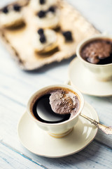 Obraz na płótnie Canvas Cup of coffee with tasty cakes on table.