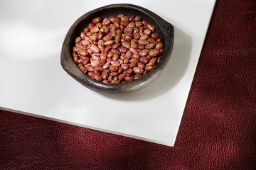pink uribe bean in clay bowl on white background