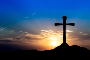 Cross on a hill at sunset