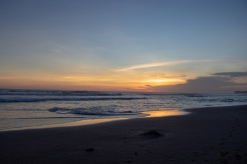 Fototapeta na wymiar Sunset over sand beach of Changgu area Echo beach,Bali island,Indonesia