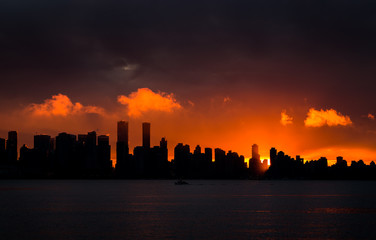 Downtown Vancouver silhouetted against the setting sun.