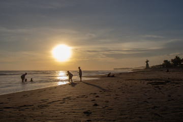 People at Echo Beach in Canggu Bali indonesia at sunset