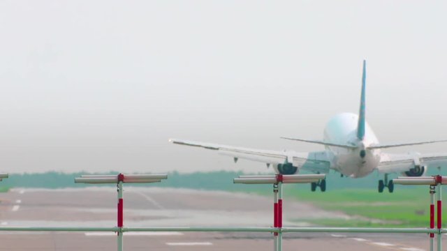 Commercial Jet Airplane Landing in airport runway. Slow Motion.