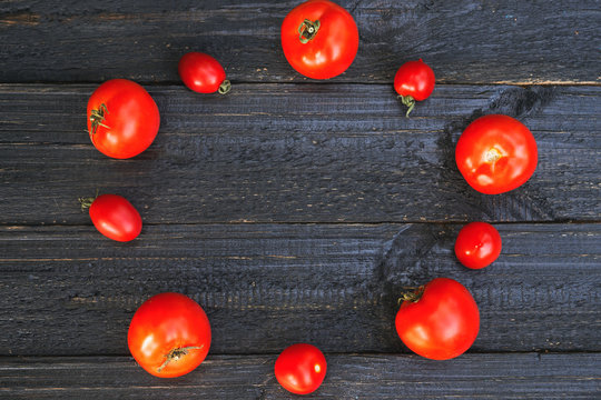 Ripe red tomatoes on a wooden table with copy space