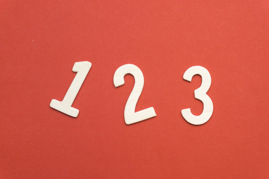 number 1 2 3 of wood on red paper