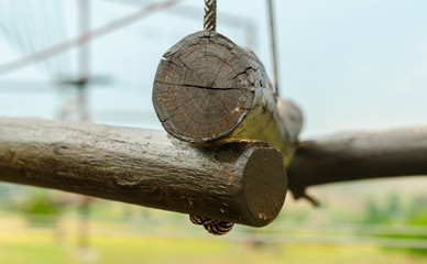 small wooden logs of a suspended rope road close-up