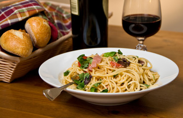 Pasta dinner with bread and wine