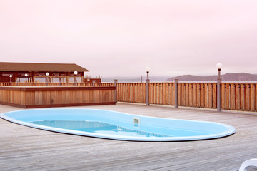 Wooden deck beach sea ocean resort sun lounger umbrella hotel pool sky sunrise