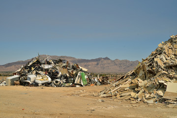 piles of household junk and debris in Mojave Desert landfill landscape Pahrump, Nevada, USA