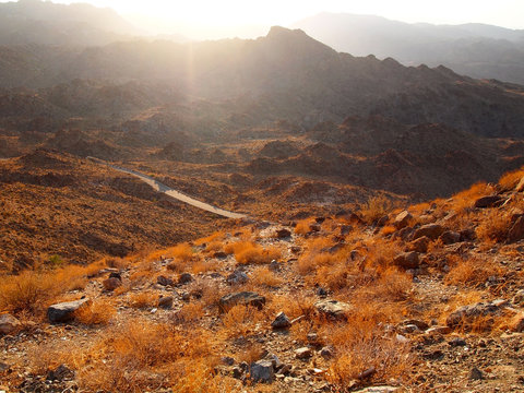 Sunset Rays Over A Desert Mountain