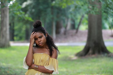 Naklejka premium Black woman feeling headache in woods