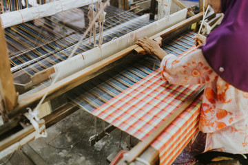 Weaving machine - use for weaving traditional Thai silk. Homemade silk or textile production in Thailand.