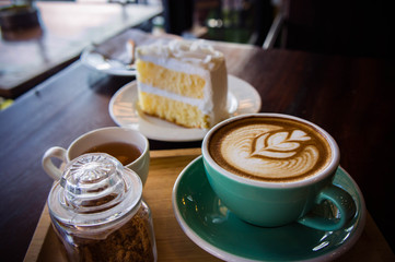 coffee time in the wood table cafe , drink coffee and tasty cake