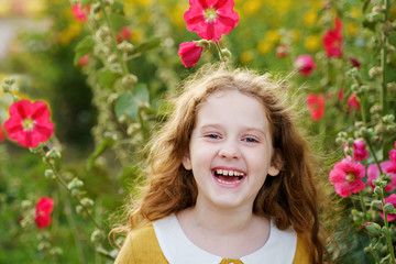 Little girl having happy eyes and showing white teeth.