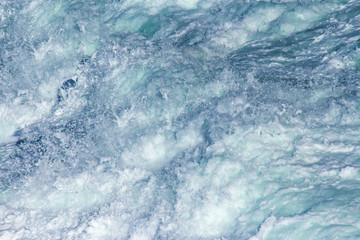Aquatic background of sea surf waves close up with clear water and white foam