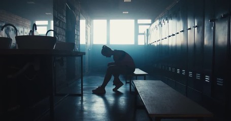 DOLLY IN Caucasian female athlete preparing for a workout in a gym locker room, tying shoelaces before training session. 4K UHD 60 FPS SLOW MOTION - Powered by Adobe