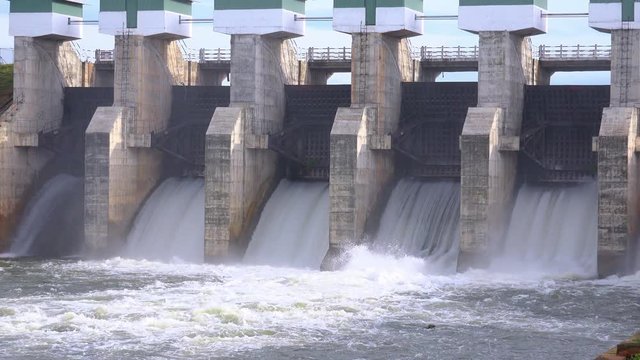 Beautiful view of Meheragala reservoir dam illuminated by sun. Impressive water barrier construction represented on Sri Lankan 5000 rupee banknote. Camera zooms out. Yala National Park, Sri Lanka.