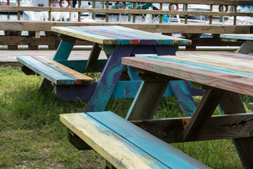 Fototapeta na wymiar Colorful picnic tables-outdoor seating near the harbor on Bald Head Island, North Carolina