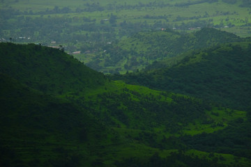 Fototapeta na wymiar Lush green monsoon nature landscape mountains, hills, farming plot, Purandar, Pune, Maharashtra, India 