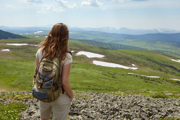 Young woman hiking in mountains. Freedom concept.