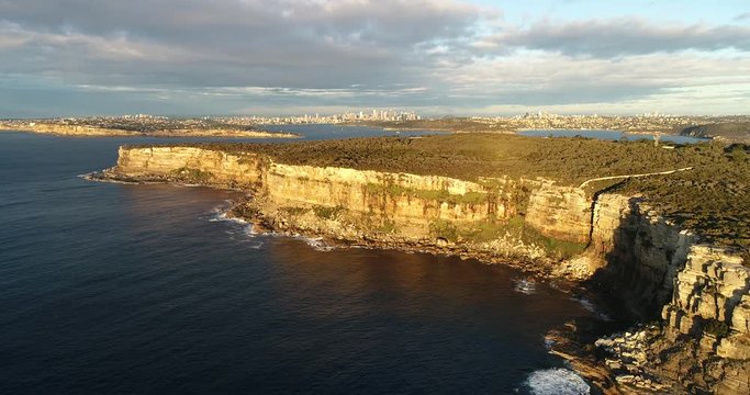 Close to sandstone cliffs of Sydney North Head around the entrance to Sydney Harbour forward to distant city CBD.
