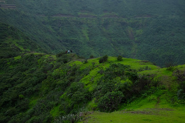 Lush green monsoon nature landscape mountains, hills, farming plot, Purandar, Pune, Maharashtra, India 
