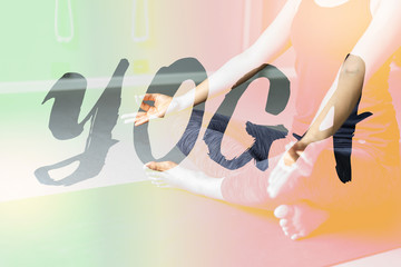 Naklejka premium Young woman practicing yoga in gray background.Young people do yoga indoor.Close up hands in meditating gesture. Copy space.