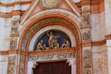 Fototapeta na wymiar A closeup view of decorative elements of the facade of a cathedral in Bologna, Italy