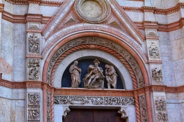 Fototapeta na wymiar A closeup view of decorative elements of the facade of a cathedral in Bologna, Italy