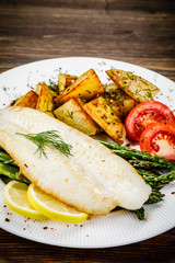 Fish dish - fried fish fillet with fried potatoes and vegetables