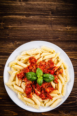 Penne with meat, tomato sauce and vegetables