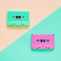 Fototapeta premium Flat lay retro colorful cassette tape on pastel color background, minimal style