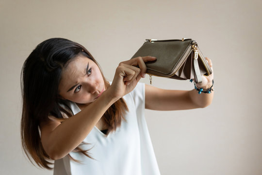 Unhappy young asian woman open her empty wallet
