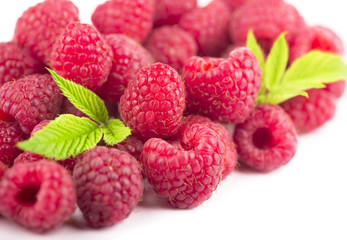 Raspberry with leaves isolated on white background