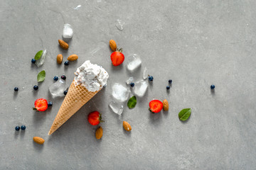 Cone with ice cream and fruits, cool dessert and summer refreshment concept