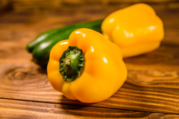 Cucumbers and sweet pepper on wooden table