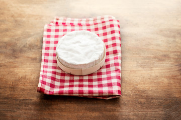 Cheese camembert on wooden desk, top view. Soft creamy cheese Brie with copy space.