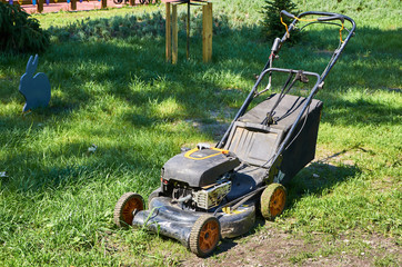 Fototapeta premium lawn mower stands on the grass