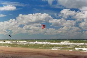 people are engaged in kitesurfing