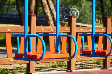 Fototapeta na wymiar Swing for children in the public playground