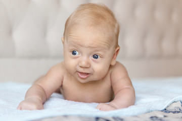 Newborn mild boy learns to hold his head