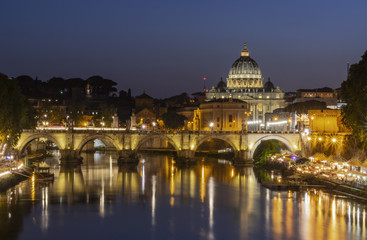 Night view at St. Peter's Basilica across the Tiber river