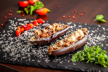 Portuguese cuisine. Baked eggplants with mushrooms, meat, vegetables and parmesan cheese. Copy space, selective focus