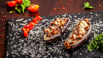 Portuguese cuisine. Baked eggplants with mushrooms, meat, vegetables and parmesan cheese. Copy space, selective focus