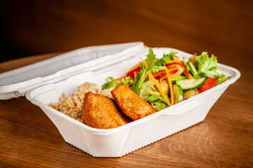 Concept of vegetarian and healthy eating. Cutlets from peas, salad, ogretsami, tomatoes, olives and porridge in eco-box of food starch. self-destructive dishes. Copy space, selective focus
