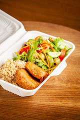 Concept of vegetarian and healthy eating. Cutlets from peas, salad, ogretsami, tomatoes, olives and porridge in eco-box of food starch. self-destructive dishes. Copy space, selective focus