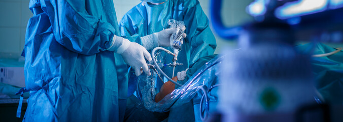 Knee surgery, Orthopedic Operation  - two surgeons performing a knee surgery on a patient (shallow DOF; color toned image) - obrazy, fototapety, plakaty