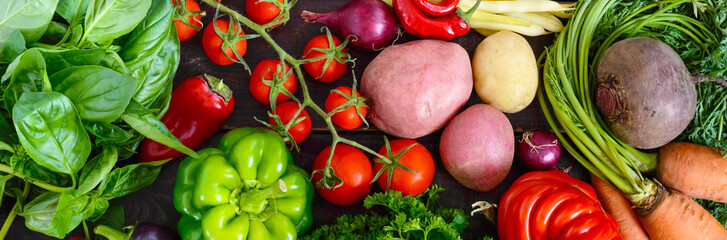 A lot of fresh organic vegetables on a wooden background. Autumn harvest. Healthy eating. Food background.