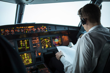 Pilot's hand accelerating on the throttle in  a commercial airliner airplane flight cockpit during...
