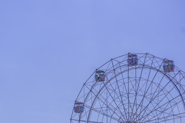 Part of Ferris Wheel with blue sky background